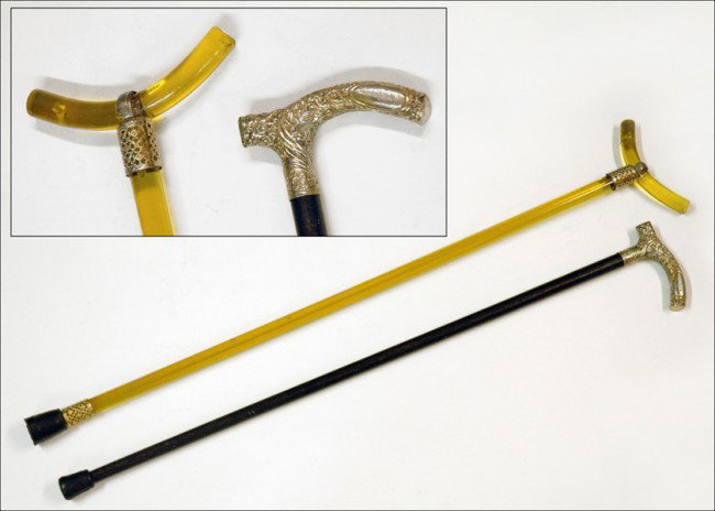 EBONIZED WOOD AND SILVERPLATE WALKING STICK.: EBONIZED WOOD AND SILVERPLATE WALKING STICK. Together with a lucite walking stick