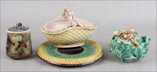 GROUP OF MAJOLICA TABLE ARTICLES.: GROUP OF MAJOLICA TABLE ARTICLES. Comprised of one cabbage form covered box with a rabbit lid, one humidor, one basket, and one pineapple motif under plate