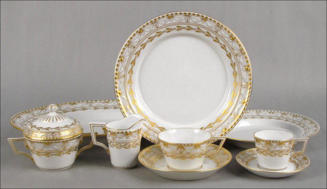KPM GILT PORCELAIN DINNER SERVICE.: KPM GILT PORCELAIN DINNER SERVICE. Comprised of eleven dinner plates, eleven salad plates, thirteen bread plates, five soup bowls, twelve bouillon cups with saucers, thirteen teacups with saucers, twe