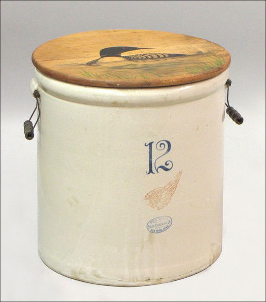 RED WING STONEWARE CROCK.: RED WING STONEWARE CROCK. With a wood lid in a loon motif 18" x 17"