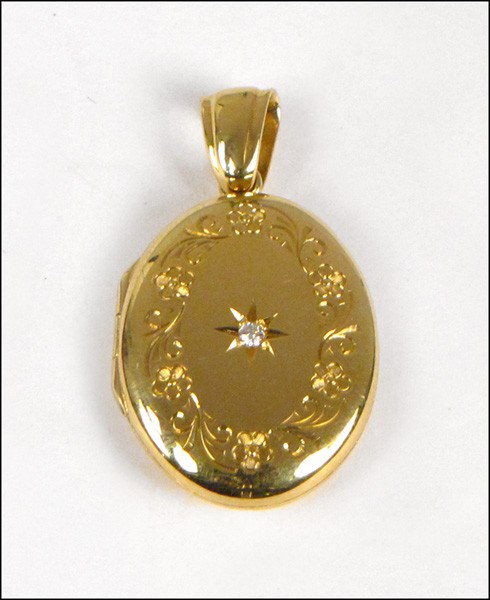 CHARLES GREEN & SONS 18 KARAT YELLOW GOLD AND D: CHARLES GREEN & SONS 18 KARAT YELLOW GOLD AND DIAMOND LOCKET.