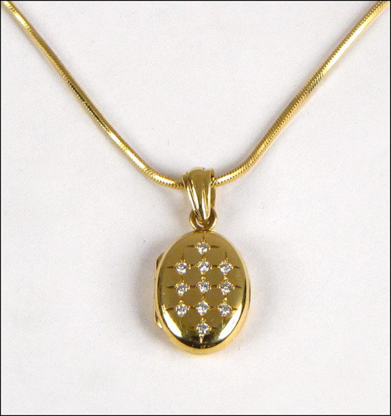 CHARLES GREEN & SONS 18 KARAT YELLOW GOLD AND D: CHARLES GREEN & SONS 18 KARAT YELLOW GOLD AND DIAMOND LOCKET WITH CHAIN. 12 grams
