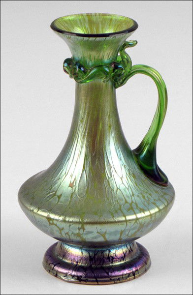 IRIDESCENT GLASS EWER.: IRIDESCENT GLASS EWER. Unsigned, in the style of Loetz Height: 6.75"