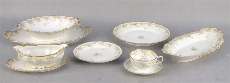 HAVILAND LIMOGES GILT TRANSFER DECORATED PORCEL: HAVILAND LIMOGES GILT TRANSFER DECORATED PORCELAIN DINNER SERVICE. Comprised of six lunehcon plates, twelve salad plates, six teacups and saucers, one sauce boat, two platters, and one open vegetable 