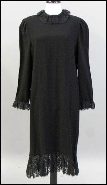 BILL BLASS BLACK CREPE DRESS.: BILL BLASS BLACK CREPE DRESS. With black lace at the collar, cuffs, along the bottom hem of the dress Approximately a size 6