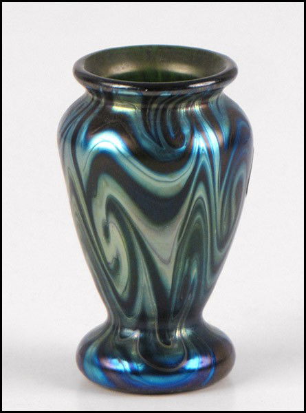 L.C. TIFFANY FAVRILE GLASS VASE.: L.C. TIFFANY FAVRILE GLASS VASE. Iridescent blue with a wavy King Tut design. Underside reads "L.C. Tiffany, Favrile, 2617S" Height: 2.75
