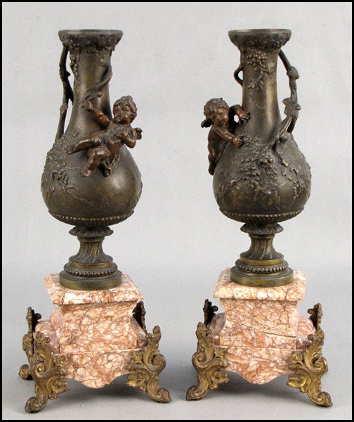 PAIR OF PATINATED BRONZE AND MARBLE URNS.: PAIR OF PATINATED BRONZE AND MARBLE URNS. Urns are signed Moreau Height: 18"