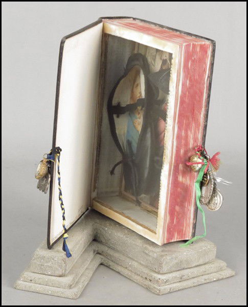 MARGARET WHARTON (AMERICAN, B. 1943) SACRED HE: MARGARET WHARTON (AMERICAN, B. 1943) SACRED HEART, 1988. Mixed media, depicting the Madonna and child within a faux bible shadowbox. Interior cover is signed, dated, and titled. Raised on a 1.5" base