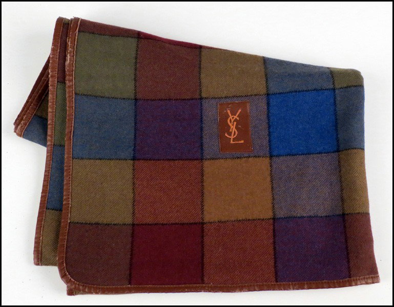 YVES SAINT LAURENT WOOL BLEND SCARF.: YVES SAINT LAURENT WOOL BLEND SCARF. Entirely trimmed in leather, and bearing an embroidered leather YSL patch 76" x 27"