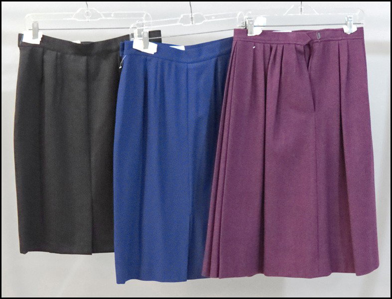 THREE YVES SAINT LAURENT WOOL SKIRTS.: THREE YVES SAINT LAURENT WOOL SKIRTS. Eggplant skirt: size 34 Purple size 44 Black skirt: Size 44