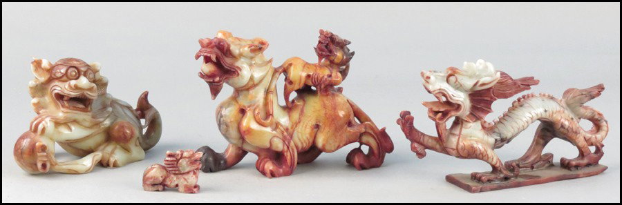 THREE CARVED SOAPSTONE DRAGONS.: THREE CARVED SOAPSTONE DRAGONS. Together with s carved soapstone foo dog Largest dragon: 7" x 10"