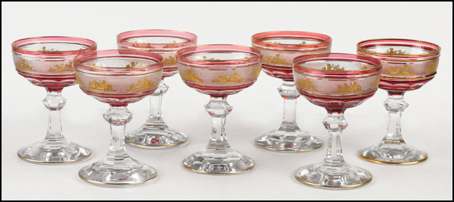 SET OF SEVEN VAL ST. LAMBERT CHAMPAGNE / SHERB: SET OF SEVEN VAL ST. LAMBERT CHAMPAGNE / SHERBET GOBLETS. Ruby cut-to-clear cystal with a gilt cherub scene, unsigned Height: 5"