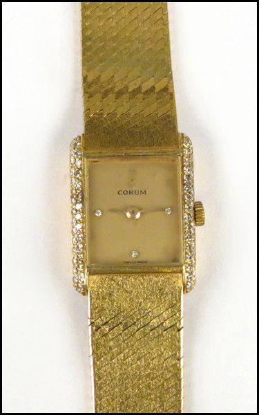 CORUM 18 KARAT YELLOW GOLD AND DIAMOND WATCH.: CORUM 18 KARAT YELLOW GOLD AND DIAMOND WATCH. Length: 6" Wt: 41 grams