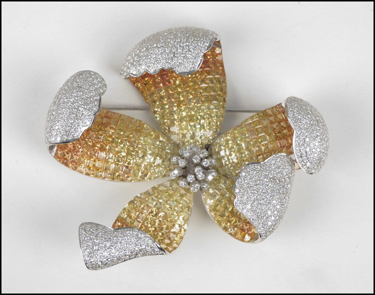 DIAMOND, SAPPHIRE, AND 18 KARAT WHITE GOLD FLO: DIAMOND, SAPPHIRE, AND 18 KARAT WHITE GOLD FLOWER CLIP / BROOCH. Pave set round diamonds total approximately 6.00 carats 3.75" x 3.75" Wt: 91 grams