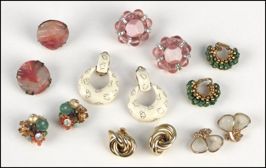 GROUP OF EARCLIPS.: GROUP OF EARCLIPS. Including one pair of Ciner white enamel earclips, one pair of Hobe pink bead earclips, one pair of Hobe goldtone twist earclips, one pair of DeMario multi-colored earclips, and thr