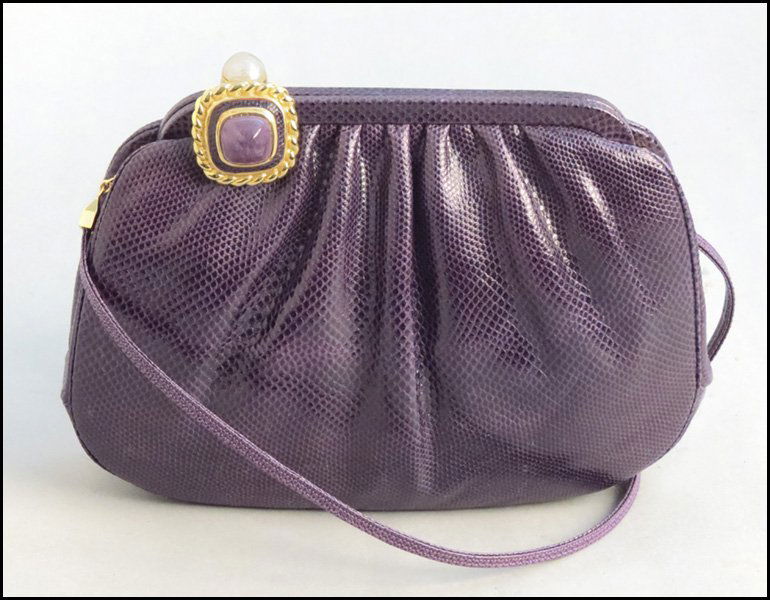 JUDITH LEIBER PURPLE REPTILE SKIN HANDBAG.: JUDITH LEIBER PURPLE REPTILE SKIN HANDBAG. With a faux pearl and amethyst closure, hand mirror, and comb 6.5" x 9.25"