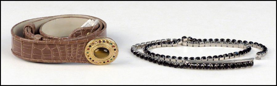 TWO JUDITH LEIBER BELTS.: TWO JUDITH LEIBER BELTS. Comprised of a black rhinestone belt, and a leather belt