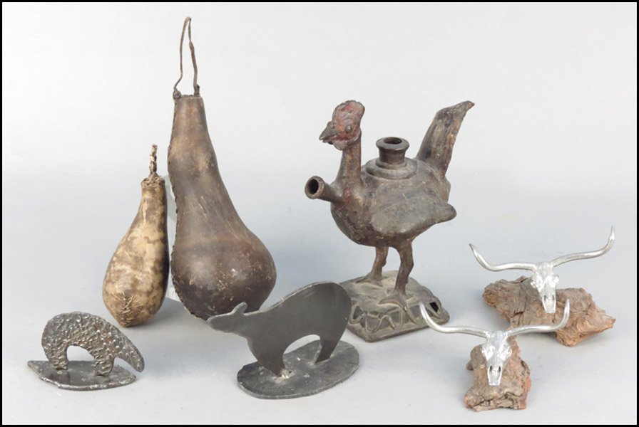 PATINATED METAL BIRD FORM VESSEL.: PATINATED METAL BIRD FORM VESSEL. Together with two metal animal skulls mounted on driftwood, two water vessels, and two metal bear figures Bird vessel height:11"