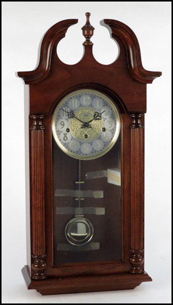 CARVED OAK SLIGH WALL CLOCK.: CARVED OAK SLIGH WALL CLOCK. H: 28" W: 14" D: 7"