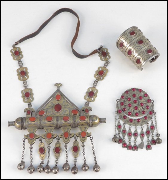 TURKOMAN TRIBAL SILVER JEWELRY.: TURKOMAN TRIBAL SILVER JEWELRY. Comprised of a glass cuff bracelet, a carnelian parcel gilt silver necklace, and a glass adorned amulet