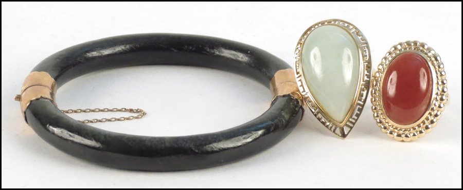 JADE AND 14 KARAT YELLOW GOLD RING.: JADE AND 14 KARAT YELLOW GOLD RING. Together with with a Carnelian and 14 karat yellow gold ring, and a bracelet