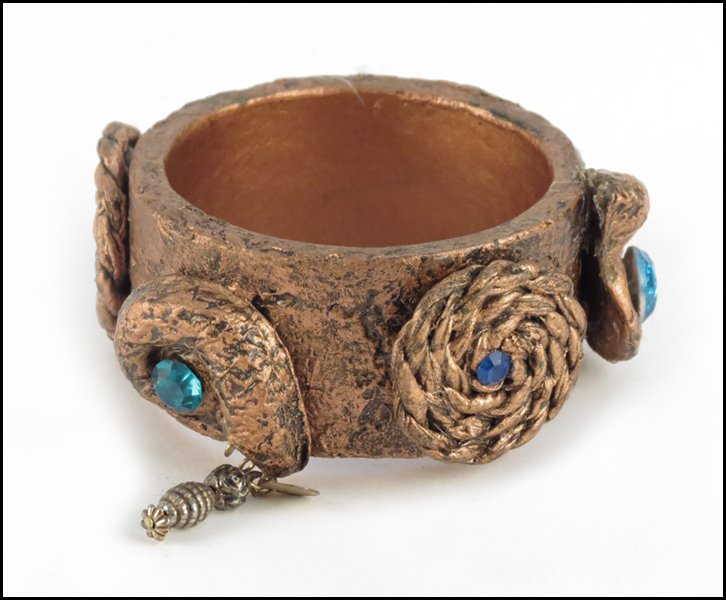 GERDA LYNGGAARD FOR MONIES, RHINESTONE AND COPP: GERDA LYNGGAARD FOR MONIES, RHINESTONE AND COPPER TONE RESIN BRACELET.