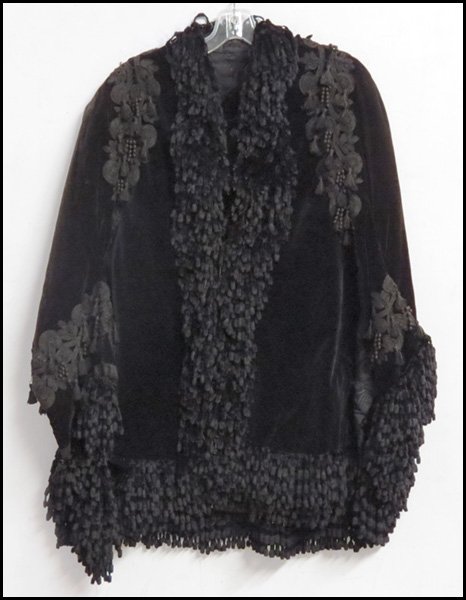 AN EDWARDIAN BLACK VELVET JACKET.: AN EDWARDIAN BLACK VELVET JACKET. Entirely lined in black sik moire
