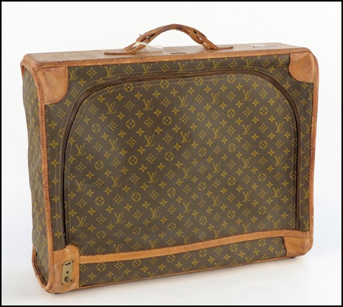 LOUIS VUITTON MONOGRAMMED CANVAS AND LEATHER PU: LOUIS VUITTON MONOGRAMMED CANVAS AND LEATHER PULLMAN SUITCASE. The French Company, for Saks Fifth Avenue H: 20" W: 25" D: 9"
