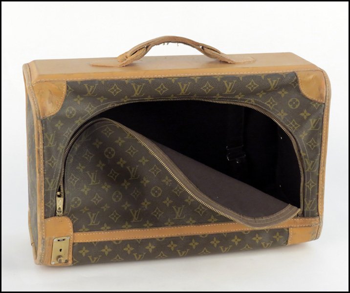 LOUIS VUITTON MONOGRAMMED CANVAS AND LEATHER PU: LOUIS VUITTON MONOGRAMMED CANVAS AND LEATHER PULLMAN SUITCASE. French Company H: 13" W: 20.5" D: 8"