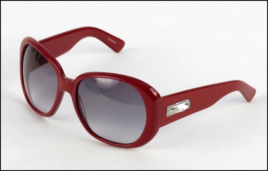 PAIR OF YVES SAINT LAURENT RED SUNGLASSES.: PAIR OF YVES SAINT LAURENT RED SUNGLASSES. With rhinestone detail along the sides