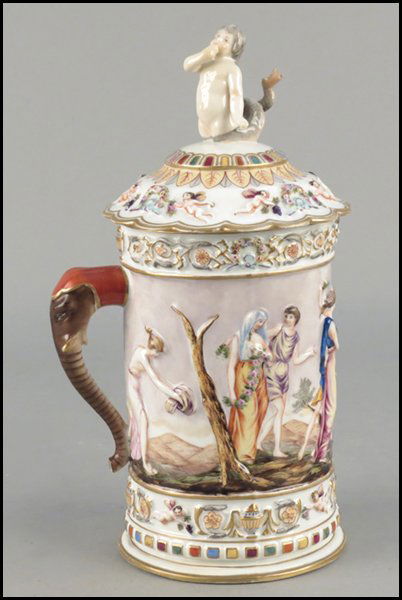 CAPODIMONTE PORCELAIN COVERED TANKARD.: CAPODIMONTE PORCELAIN COVERED TANKARD. Depicting a Neoclassical scene. Bearing an elephant form hadle, with a cherubic sea creature finial Height: 13"