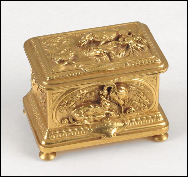 FRENCH GILT BRONZE BOX.: FRENCH GILT BRONZE BOX. Depicting the store of The Wolf and The Crane. Cover of box, front, and reverse all bear impressed "Le Loup et La Cigogne". Front panel is signed T. Hingre, for Theophile Louis