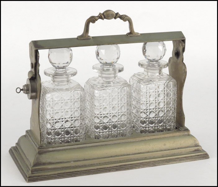 DANIEL & ARTER ENGLISH SILVERPLATE TANTALUS.: DANIEL & ARTER ENGLISH SILVERPLATE TANTALUS. Containing a set of three cut glass decanters H: 12.5" W: 15.75" D: 7"