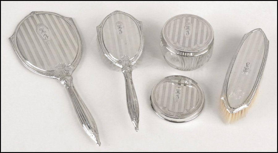 STERLING SILVER VANITY SET.: STERLING SILVER VANITY SET. Comprised of a hand mirror, hairbrush, clothing brush, covered glass jar, and one extra lid