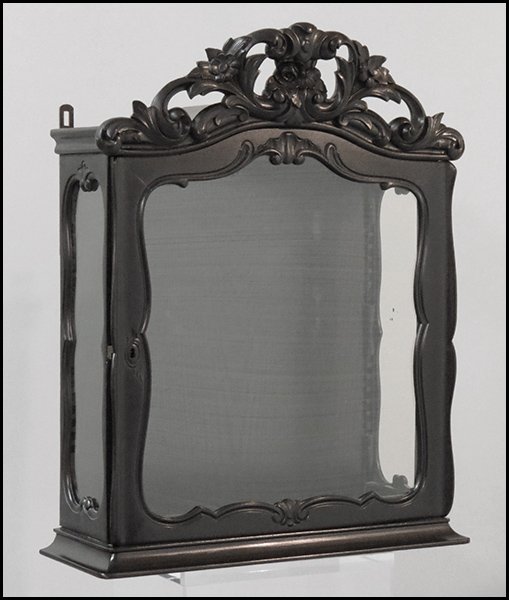 CARVED EBONIZED WOOD WALL MOUNTED VITRINE.: CARVED EBONIZED WOOD WALL MOUNTED VITRINE.