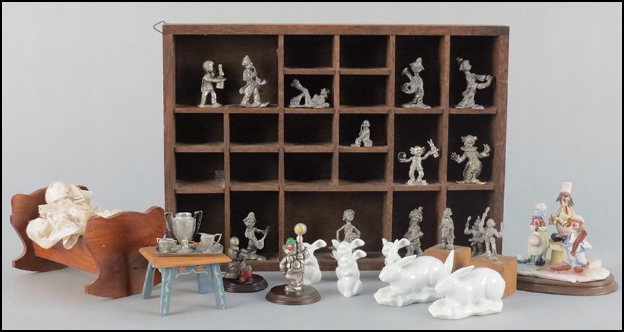 COLLECTION OF CHILDREN'S DECORATIVE ITEMS.: COLLECTION OF CHILDREN'S DECORATIVE ITEMS. Six Limoges and German porcelain rabbits, Zampiva porcelain clown figural group, a porcelain doll in a wood cradle, a pewter miniature teaset, a wood doll st