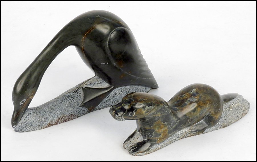 TWO INUIT STONE CARVINGS.: TWO INUIT STONE CARVINGS. Comprised of a bird, and a seal. Both carvings bear etched numbers, and are dated 1988 Larger: 5.5" x 9.5" x 3"