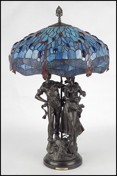 BRONZE TABLE LAMP.: BRONZE TABLE LAMP. Depicting male and female couple. L.A. Bencontre reproduction attributed to Augusto Moreau. With a Tiffany style slag glass shade (diameter 21") Height 21"