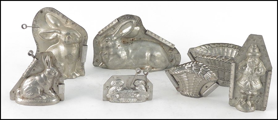 COLLECTION OF HOLIDAY CHOCOLATE MOLDS.: COLLECTION OF HOLIDAY CHOCOLATE MOLDS. Includes four rabbit molds, two baskets, and a santa Claus mold. Includes molds by Eppelsheimer and company Tallest Height 7.5"