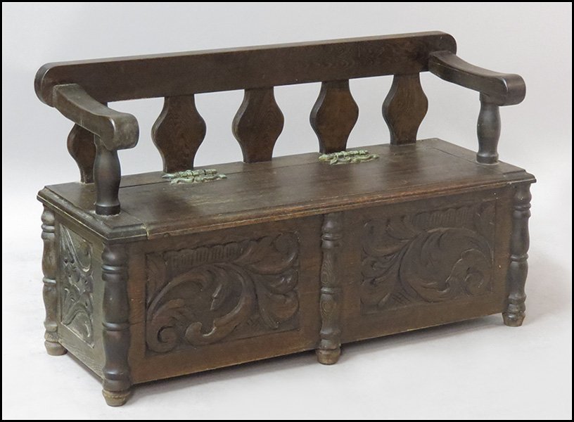CARVED OAK HALL BENCH.: CARVED OAK HALL BENCH. With a lift top storage compartment H: 29" W: 48" D: 17"