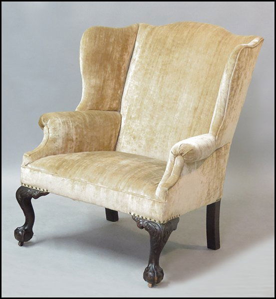 GEORGIAN STYLE WINGBACK CHAIR.: GEORGIAN STYLE WINGBACK CHAIR. Raised on mahogany ball and claw feet H: 43" W: 36" D: 35"