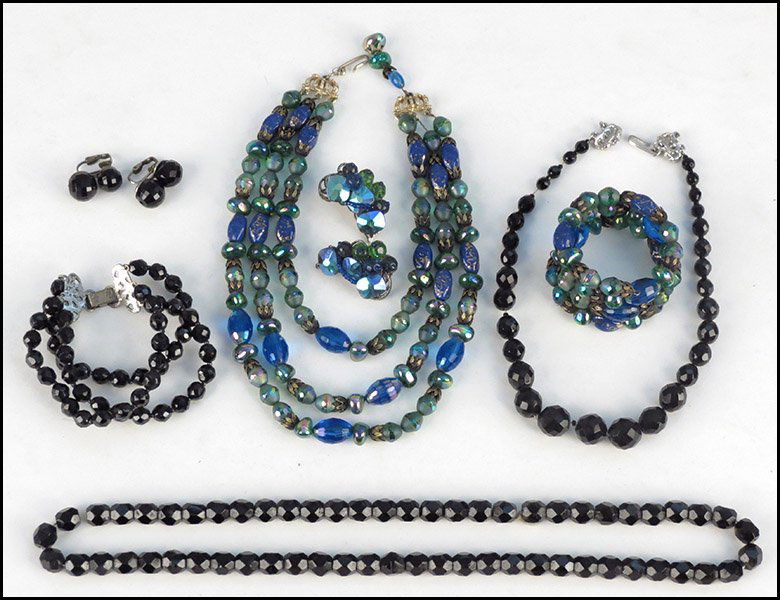 HOBE TRIPLE STRAND GREEN AND BLUE BEAD NECKLACE.: HOBE TRIPLE STRAND GREEN AND BLUE BEAD NECKLACE. Together with a pair of Robert blue and green earclips, a blue and green coil bracelet, a faceted black glass bead triple strand bracelet, a black face