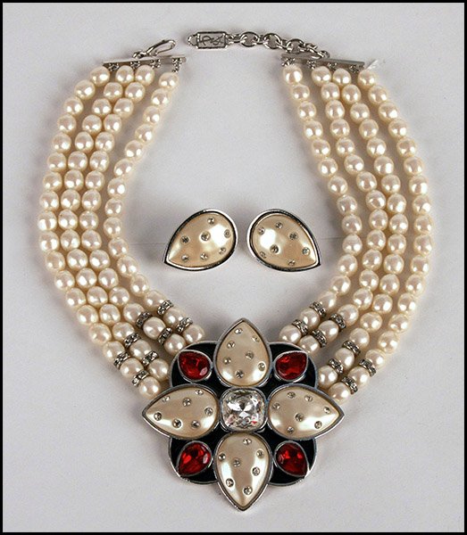 YVES SAINT LAURENT DEMI-PARURE.: YVES SAINT LAURENT DEMI-PARURE. Comprised of a four-strand faux pearl and rhinestone necklace, leading into a black enamel and rhinestone medallion, and a pair of tear drop earclips. Necklace is editi
