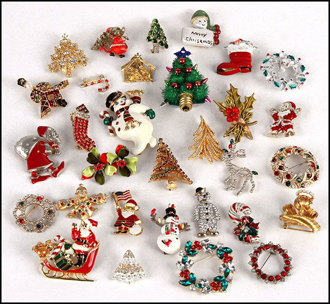COLLECTION OF CHRISTMAS JEWELRY.: COLLECTION OF CHRISTMAS JEWELRY. Comprised of brooches and earrings, by Bob Mackie, Lisner, ART, Eisenberg, Joan Rivers, and one sterling silver and enamel Santa brooch