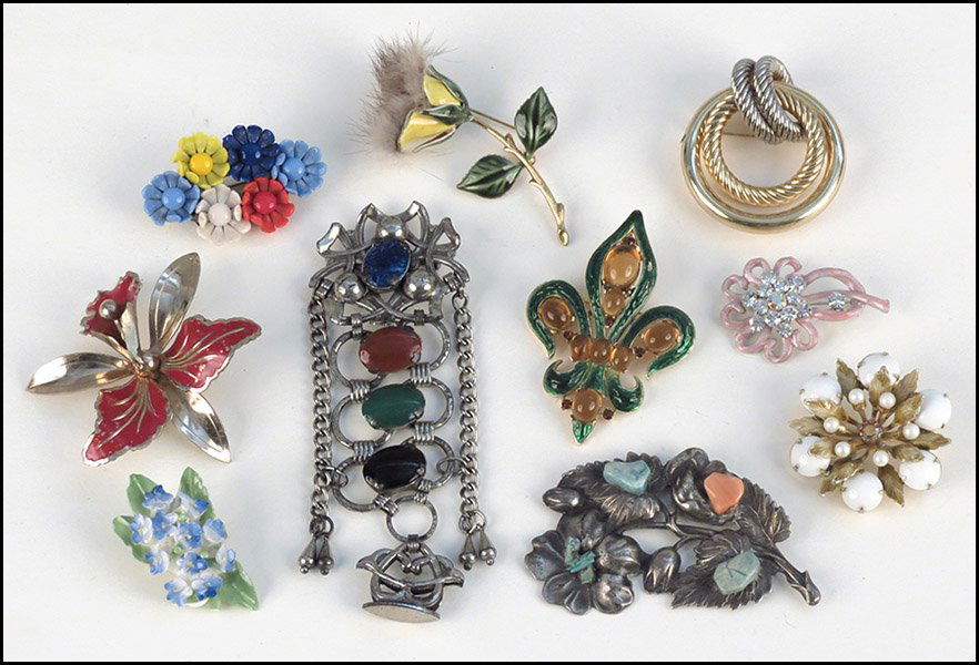 TRIFARI FLEUR-DE-LIS ENAMEL BROOCH.: TRIFARI FLEUR-DE-LIS ENAMEL BROOCH. Together with an Alice Caviness white bead floral brooch, a Christian Dior gold tone knot brooch, a pink enamel and rhinestone floral brooch, a Victorian style broo