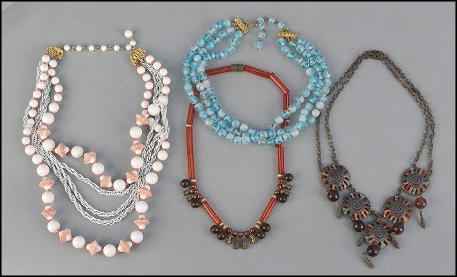 HATTIE CARNEGIE BLUE BEAD THREE-STRAND NECKLACE.: HATTIE CARNEGIE BLUE BEAD THREE-STRAND NECKLACE. Together with a Hobe orange and white bead and chain link necklace, an unsigned metal and plastic link necklace, and an unsigned metal medallion style 