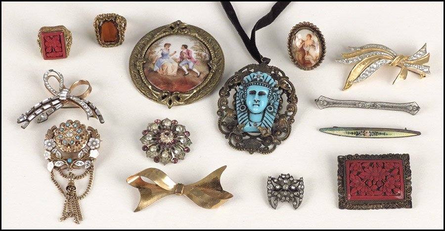 CINNABAR BROOCH AND RING.: CINNABAR BROOCH AND RING. Together with two rings, nine brooches, and one Egyptian style pendant necklace