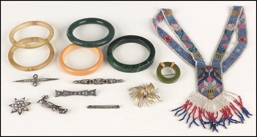 BAKELITE BRACELET AND CIRCLE BROOCH.: BAKELITE BRACELET AND CIRCLE BROOCH. Together with four plastic bracelets, a beaded necklace, and seven rhinestone brooches