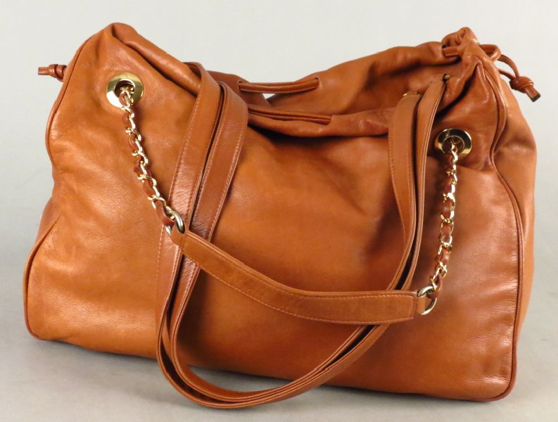 HENRI BENDEL BROWN LEATHER HANDBAG.: HENRI BENDEL BROWN LEATHER HANDBAG. With two sets of straps: one is long solid leather, and the other is gold tone links with brown leather H: 12" W: 14.5" D: 6"