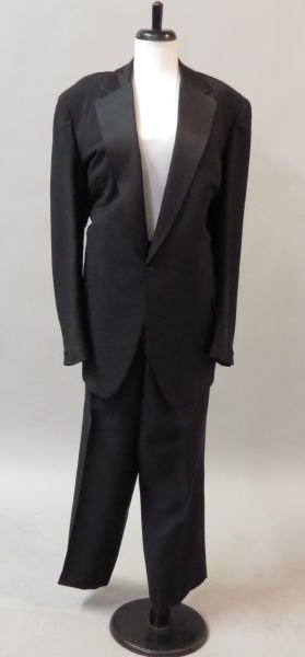 PUCCI MEN'S BLACK WOOL AND SATIN TUXEDO.: PUCCI MEN'S BLACK WOOL AND SATIN TUXEDO. Jacket bears a knotched lapel and a black, white, and red logo silk lining Jacket is approximately size 46-48